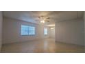 Bright and airy living room with tile flooring, ceiling fan and natural light from two windows at 4725 Michael Ct # 131, Tampa, FL 33614