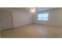 Spacious living room with tile flooring, ceiling fan and natural light from window at 4725 Michael Ct # 131, Tampa, FL 33614