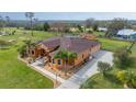 Expansive home on a large lot featuring a long driveway and additional outbuildings on a lush and verdant property at 14739 Vista View Ct, Dade City, FL 33523