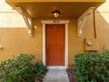Close-up of the front door showcasing the house number and well-maintained entrance with manicured shrubs at 4734 Chatterton Way, Riverview, FL 33578