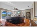 Spacious living room with hardwood floors, a ceiling fan, and water views provides a relaxing ambiance at 1881 Riveredge Dr, Tarpon Springs, FL 34689