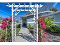 Home's beautiful pathway to entrance, adorned with bougainvillea plants at 245 58Th N St, St Petersburg, FL 33710