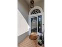 Front entryway featuring a decorative storm door and brick flooring at 27045 Firebush Dr, Wesley Chapel, FL 33544