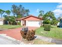 Lovely home with a brick driveway, well-kept lawn, and attractive landscaping creating curb appeal at 7425 118Th Dr, Largo, FL 33773