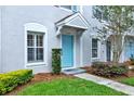 Charming home featuring a light blue front door and light blue shutters in a well manicured landscape at 8541 Hunters Key Cir, Tampa, FL 33647