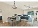 Comfortable living room adjacent to the dining area, features stylish seating and a sliding glass door at 8541 Hunters Key Cir, Tampa, FL 33647