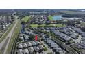 Stunning aerial view of the community showcasing the well-maintained homes, lush landscaping, and proximity to a serene golf course at 9233 Souchak Dr, Trinity, FL 34655