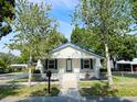 Charming home with a well-maintained lawn, adorned with mature trees and a classic fence at 14124 Plum Ln, Hudson, FL 34667