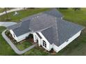 Drone shot highlighting the roof of a property, lush landscaping, and curved walkway leading to the front door at 7425 245Th E St, Myakka City, FL 34251