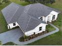 Birds-eye view of a home featuring new roofing, landscaping, and a driveway leading to the garage at 7425 245Th E St, Myakka City, FL 34251