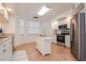 Bright kitchen with an island, granite countertops, and stainless steel appliances at 960 Starkey Rd # 3106, Largo, FL 33771