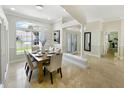 Dining room featuring a decorative column and a view through the home to the entry at 1123 Hounds Run, Safety Harbor, FL 34695