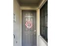 Charming front door adorned with a floral wreath and a modern security system at 17520 Gawthrop Dr # 106, Lakewood Ranch, FL 34211
