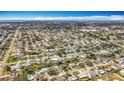 Expansive aerial view showcasing the neighborhood's layout, green spaces, and proximity to the water at 3124 61St N Ln, St Petersburg, FL 33710