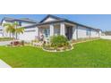 Inviting single-Gathering home with a lush front yard and covered entryway, perfect for welcoming guests at 33277 Rosewood Bark Way, Wesley Chapel, FL 33545