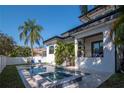 Backyard pool and jacuzzi featuring a sleek design and modern patio furniture at 4604 W Lowell Ave, Tampa, FL 33629