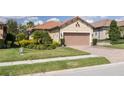 Charming home with a well-maintained lawn, tidy landscaping, and a two-car garage at 11563 Callisia Dr, Odessa, FL 33556