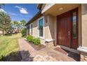 Inviting front entryway with a brick paver walkway and charming, well-maintained landscaping at 11563 Callisia Dr, Odessa, FL 33556