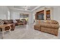 Inviting living room with a plush leather sectional sofa and custom-built entertainment center at 11563 Callisia Dr, Odessa, FL 33556