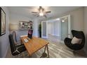 Bright home office with modern desk setup, stylish decor, and comfortable egg chair near frosted french doors at 12779 Fisherville Way, Riverview, FL 33579