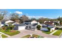 Expansive aerial view showcasing the home, circular driveway, landscaping, and solar panels at 15701 Springmoss Ln, Tampa, FL 33624