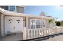 Welcoming front porch with elegant columns, decorative railings, double doors, and large window for natural light at 15701 Springmoss Ln, Tampa, FL 33624