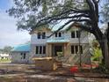 Two-story home under construction featuring block walls, wood framing, and a blue tiled roof at 515 Bosphorous Ave, Tampa, FL 33606