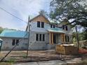 View of a two-story home under construction with block walls and wood framing, awaiting finishing touches at 515 Bosphorous Ave, Tampa, FL 33606