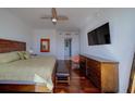 Large bedroom with a king-sized bed, ceiling fan, and built-in storage with private balcony access at 10 Papaya St # 1404, Clearwater Beach, FL 33767