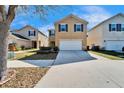 Inviting two-story home with a well-manicured lawn, spacious driveway, and attractive curb appeal at 12239 Fawn Brindle St, Riverview, FL 33578