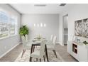 Dining room with a glass table, seating for six, and modern hanging lights at 32346 Sapna Chime Dr, Wesley Chapel, FL 33545