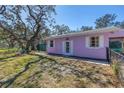 Angle view of a single-story home with a fenced yard and a well-maintained lawn at 5010 109Th N Way, St Petersburg, FL 33708