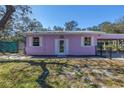 Charming single-story home with a colorful exterior, white trim, and a well-maintained front lawn at 5010 109Th N Way, St Petersburg, FL 33708