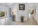 Elegant foyer with tiled floors, decorative table, and a view into other rooms at 650 Saxony Blvd, St Petersburg, FL 33716