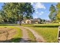 Lovely home on expansive lot with tree lined gravel driveway and fenced yard at 7213 Jones Rd, Odessa, FL 33556