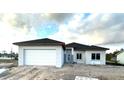 Newly built home with an attached garage and modern design elements at 13224 Foresman Blvd, Port Charlotte, FL 33981