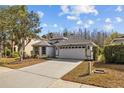 Charming single-story home with a well-maintained front yard and a two-car garage at 18861 Maisons Dr, Lutz, FL 33558