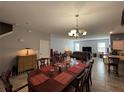 Bright and spacious living room with tiled floors, chandelier, and dining area perfect for gatherings at 20314 Starfinder Way, Tampa, FL 33647