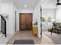 Welcoming entryway featuring hardwood floors, wooden doors, and seamless access to the cozy living area at 4406 W Euclid Ave, Tampa, FL 33629