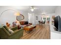 Bright living room featuring hardwood floors, modern furnishings, and an open concept layout at 1230 7Th Ne Ave, Largo, FL 33770
