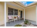 Cozy front porch with seating, decorative plants, and a welcoming entrance to the home at 1230 7Th Ne Ave, Largo, FL 33770