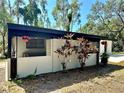 Well-maintained exterior featuring lovely landscaping and a cozy outdoor space at 1501 Howard Pl, Largo, FL 33770