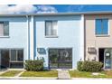 Exterior view featuring sliding glass doors, tidy landscaping, and a well-kept facade at 1849 Abrico Dr # 4, Lutz, FL 33558