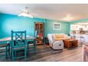 Bright living room with an open floor plan, dining area, and a kitchen bar with white cabinets at 1849 Abrico Dr # 4, Lutz, FL 33558