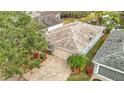 A charming home featuring a brick driveway, tropical landscaping, and proximity to a tranquil pond at 29523 Waggle Dr, San Antonio, FL 33576