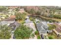 Aerial view showcasing a home's proximity to a serene pond and surrounding neighborhood at 29523 Waggle Dr, San Antonio, FL 33576