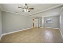 A wide open living room featuring neutral tones, ceiling fan, and tile flooring at 4101 W Leila Ave, Tampa, FL 33616