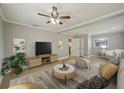 Cozy living room featuring neutral tones, ceiling fan, and minimalist decor with lots of natural light at 4101 W Leila Ave, Tampa, FL 33616
