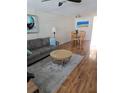 Cozy living room featuring a gray sofa, round glass table, and modern artwork at 4915 Bay Ne St # 322, St Petersburg, FL 33703