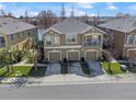 Serene aerial view showcases a townhome with three-car garage, balcony, and lush surrounding landscape at 8835 Moonlit Meadows Loop, Riverview, FL 33578
